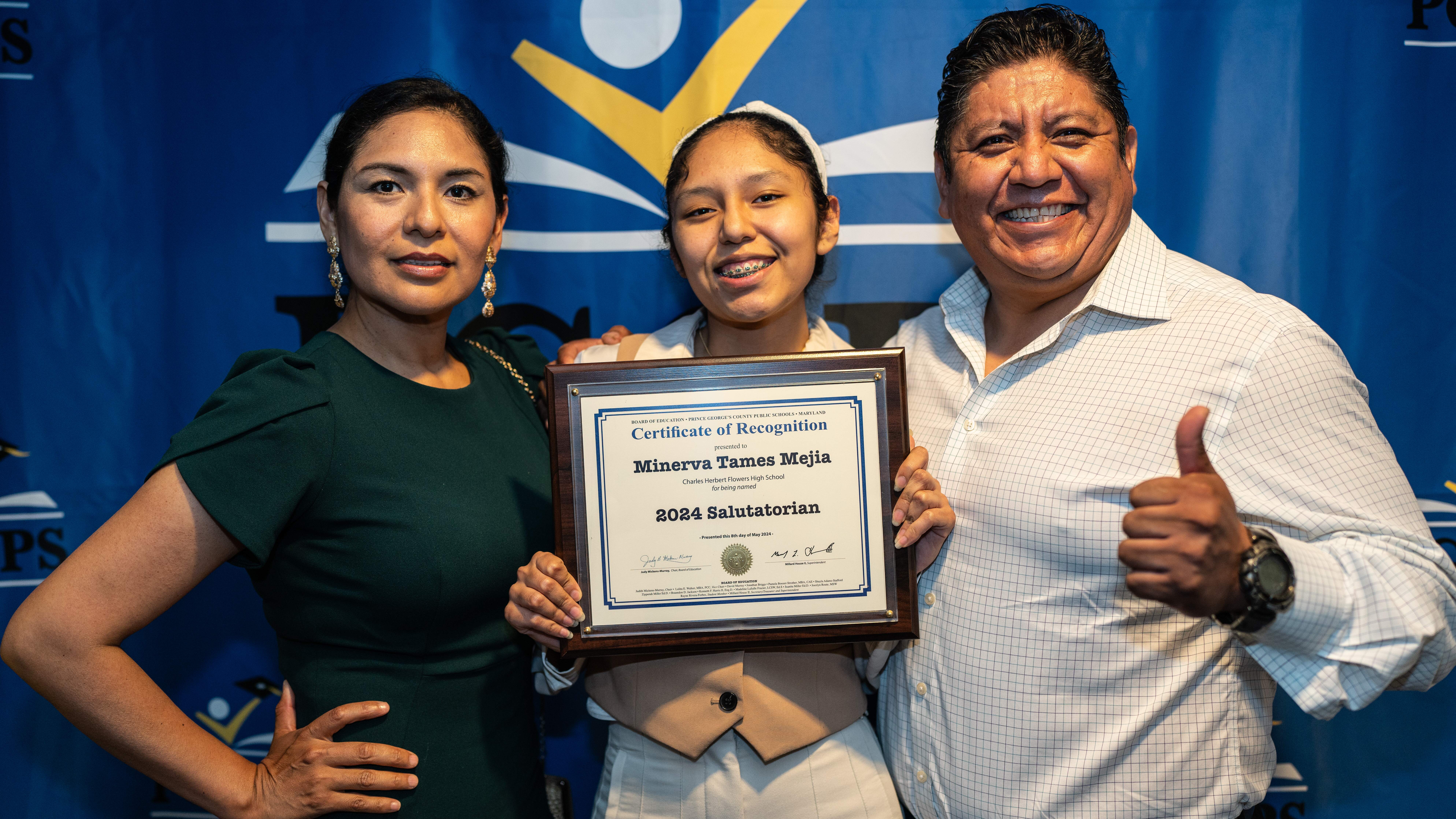 Student with Parents Holding Salutatorian Plaque.jpg