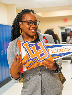 Teacher holding banners.png