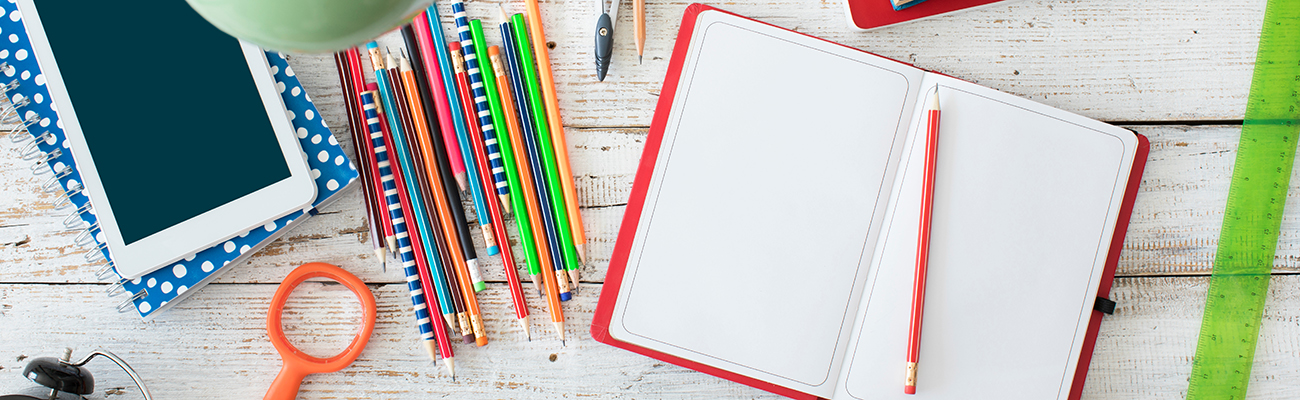 desk-with-notebook-pencils-paperclips-ruler-tablet-office