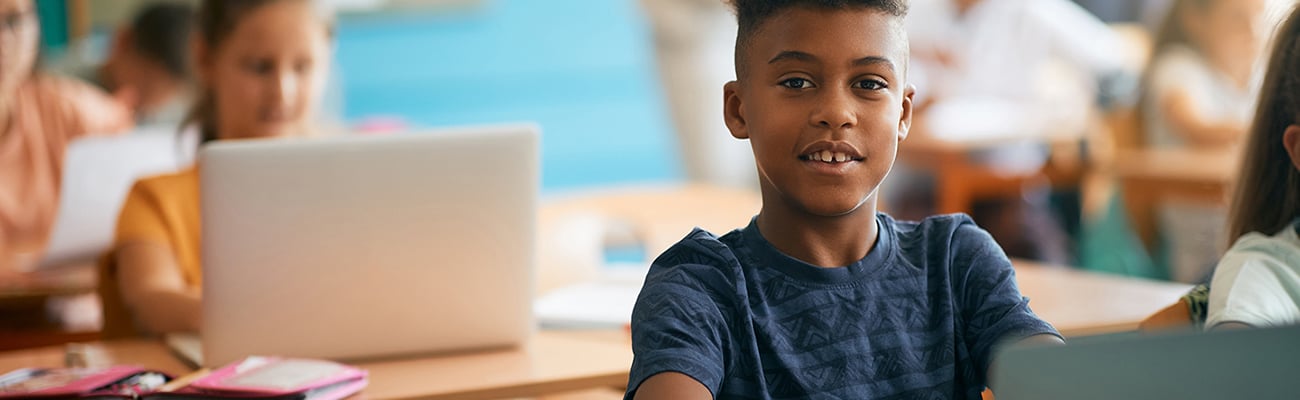 students on laptops in classroom