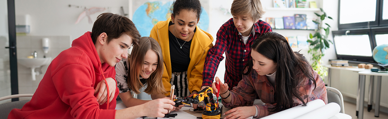 middle school students working with robotics