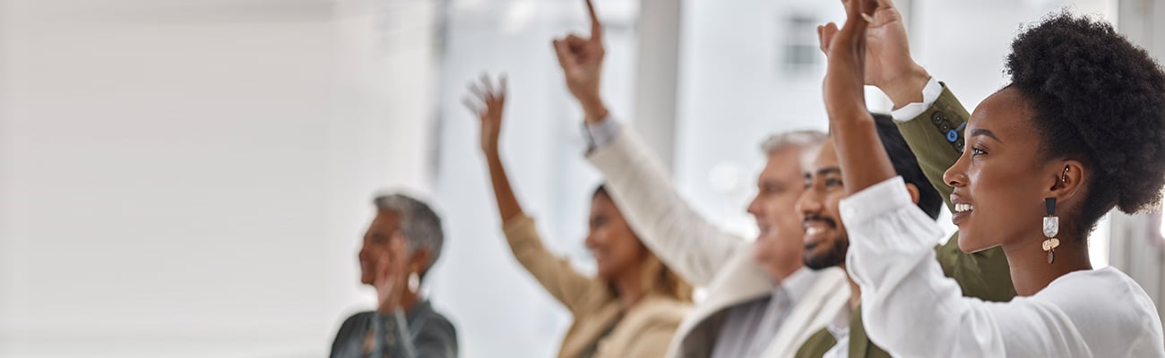 adults in group raising hands