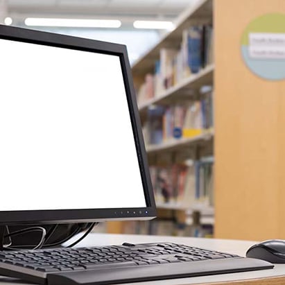 PD-computer-sitting-on-desk-in-library.jpg